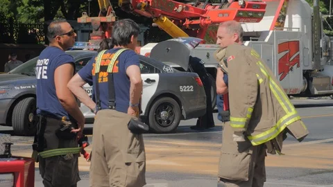 Toronto Emergency Crime Scene Intersection Firemen Police Group Discussion Video stock 91015116