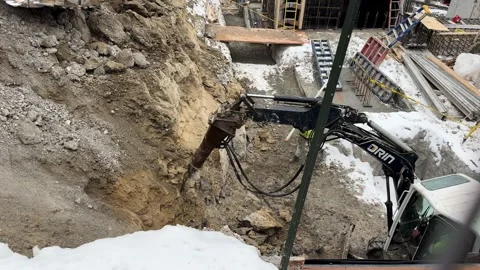 Toronto Excavator in Action at Snowy Construction Site Stock Footage 331311458