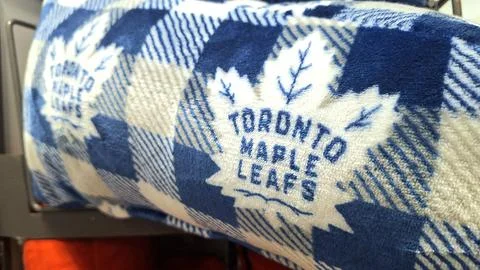 Toronto Maple Leafs blanket shows team spirit indoors. Stock Photos
