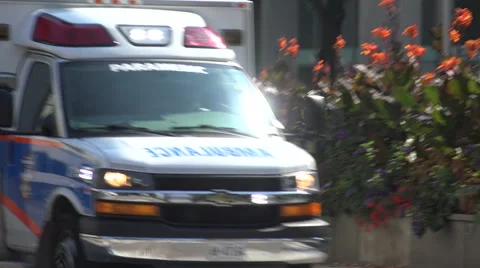 Toronto paramedic ambulance emergency service vehicle, flashing lights, siren Stock Footage