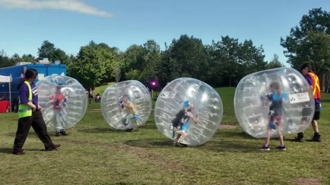 Toronto - People Playing Bubble Soccer at Buskerfest Outdoor Event Park Stock Footage 345071733