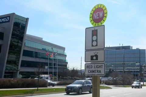 Toronto red light camera sign with AMD buildings behind Stock Photos