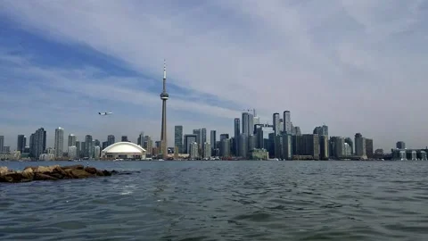 Toronto waterfront with plane taking off Stock Footage