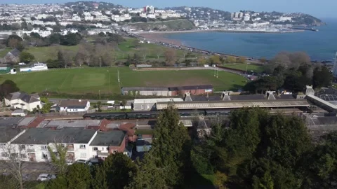 Torquay, Devon, England: Drone View: A train arrives at Torquay railway station Stock Footage 172455181
