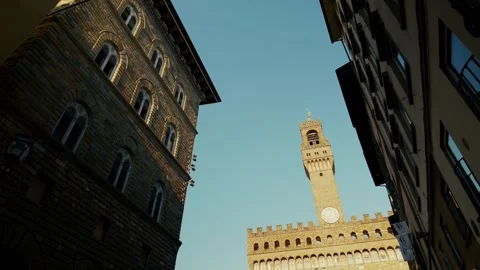 Torre di Arnolfo framed by a narrow street, Florence, low angle tilt up Stock Footage 345737989