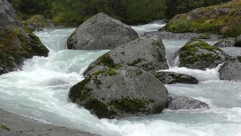 Torrent fast flowing river rocks Stock Footage 77338999