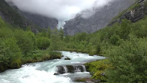 Torrent wild river Briksdal Glacier Stock Footage 77342302