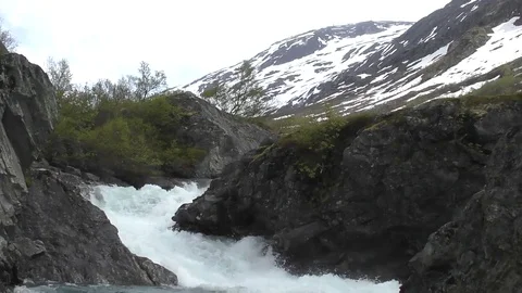 Torrent wild river slowmo mountains snow Norway Stock Footage 77342378