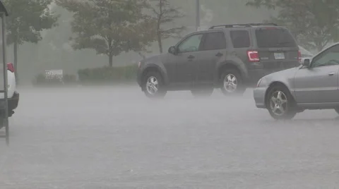 Torrential rain in urban city setting in heavy thunder storm Stock Footage