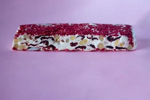 Torrone or nougat bar with nuts and red dried berries Stock Photos