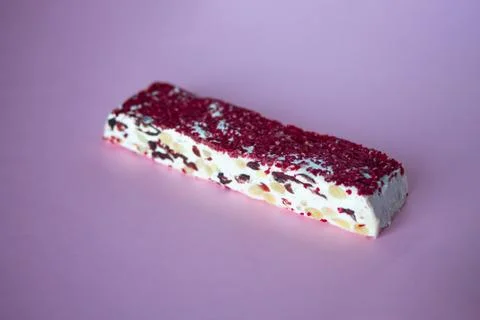 Torrone or nougat bar with nuts and red dried berries Stock Photos