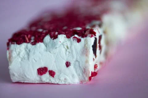Torrone or nougat bar with nuts and red dried berries Stock Photos