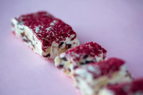 Torrone or nougat bar with nuts and red dried berries Stock Photos