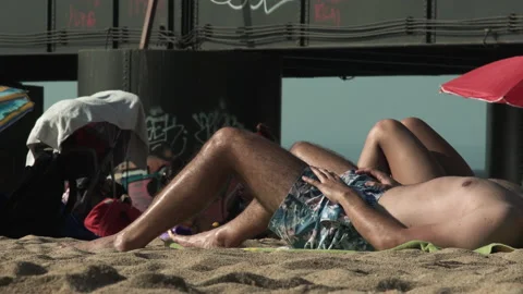 Torso of man sunbathing on the beach sand Stock Footage 137365039