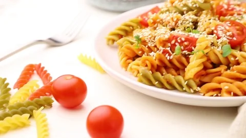 Tortiglioni pasta with tomato, microgreen sprouts and sesame seeds. Stock Footage