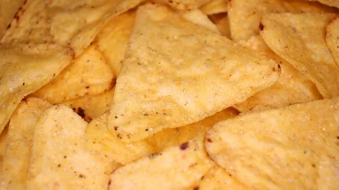Tortilla chips corn chips fast food closeup texture pattern. Seamless looping Stock Footage 102589425