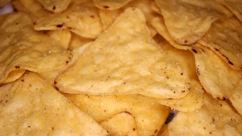 Tortilla chips corn chips fast food closeup texture pattern. Seamless looping Stock Footage 102592019