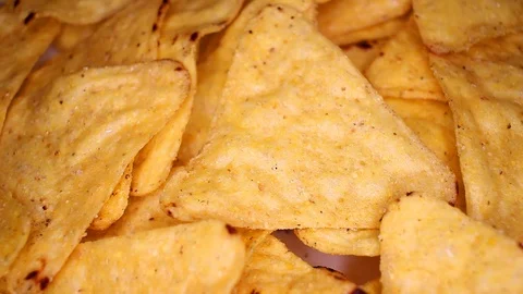 Tortilla chips corn chips fast food closeup texture pattern. Seamless looping Stock Footage 102592078