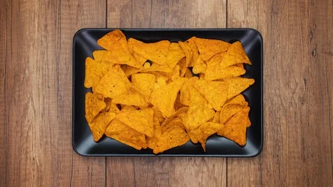 Tortilla chips filling a rectangular plate - stop motion animation Video stock 124232164