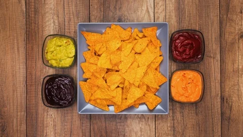 Tortilla chips filling a rectangular plate - stop motion animation Video stock 124325880