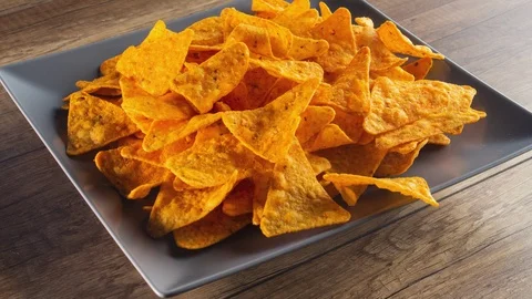 Tortilla chips filling a rotating rectangular plate - stop motion animation Видео 124232765