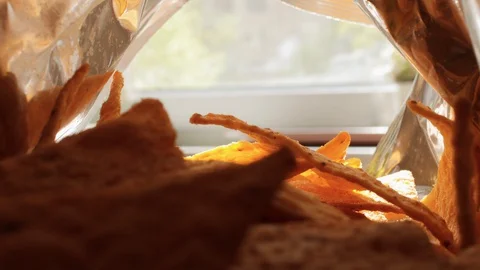 Tortilla chips, hand in a package of chips, mexican food, eat tortilla chips Stock Footage 129628461