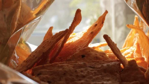 Tortilla chips, hand in a package of chips, mexican food, eat tortilla chips Video stock 129628615