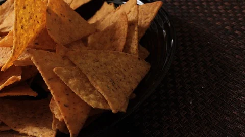 Tortilla chips, hand in a package of chips, mexican food, eat tortilla chips Video stock 129628751