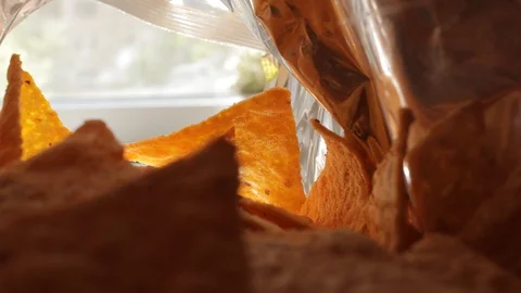 Tortilla chips, hand in a package of chips, mexican food, eat tortilla chips Video stock 129629954