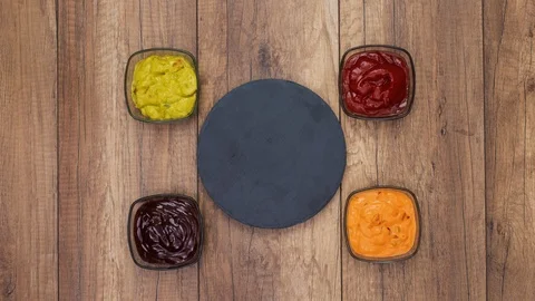 Tortilla chips piling up on a black slate plate - stop motion animation Video stock 126940712