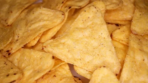 Tortilla corn chips closeup texture video on rolling rotating looping plate Stock Footage 104325179