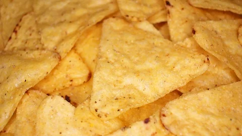 Tortilla corn chips closeup texture video on rolling rotating looping plate Stock Footage 104334311