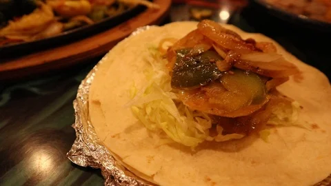 Tortilla with Toppings and Salsa on Table in Mexican Restaurant in USA Vidéo 126945643