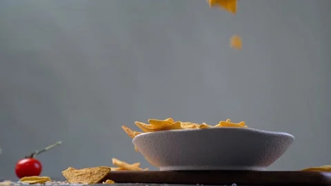 Tortillas chips falling down in white bowl Stock Footage 154273587