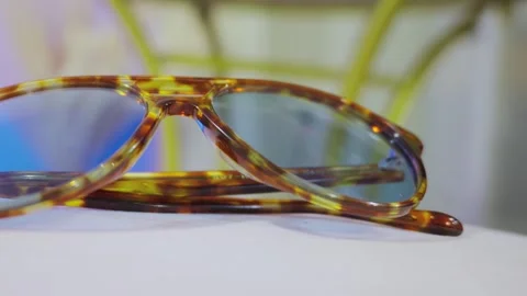 Tortoise shell aviator sunglasses with blue tinted lenses Stock Footage 332589838