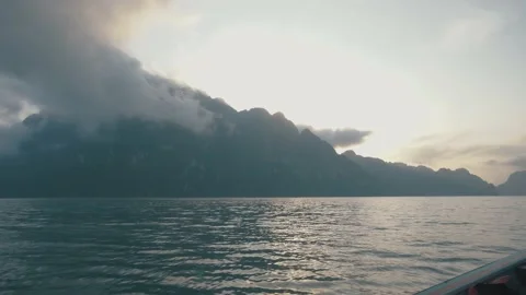 Toss Boat Floating in water with View Mountain in Evening Stock Footage 154016985
