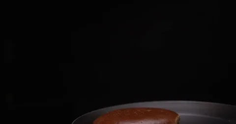 Toss round bread product in the pan. Stockbeeldmateriaal 70319834