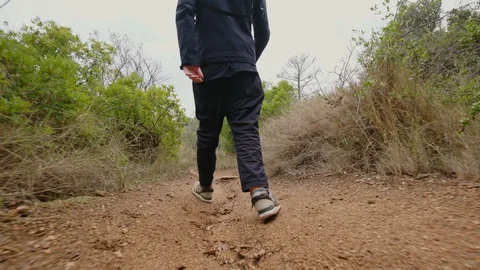 TOSSA DE MAR, SPAIN - CIRCA 2018: A man walking along the forest trail in the Stock Footage 98317407