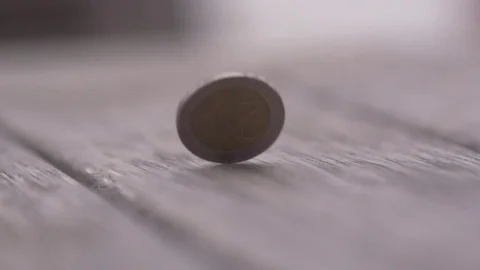 Tossed coin moving on the table in slow motion Stock Footage 77810391
