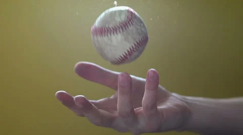 Tossing baseball in hand slow motion Stock Footage
