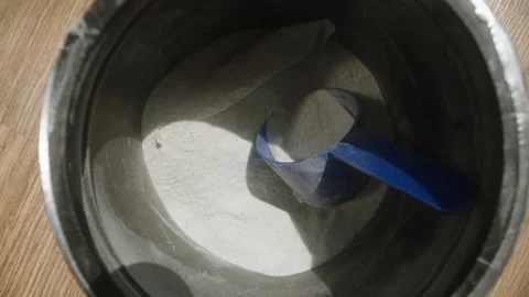 Tossing the blue scoop back into the pre-workout powder jar, deciding against Stock Footage 283789424