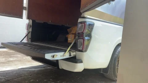 Tossing brown box package to pick up truck. Stock Footage 225125878