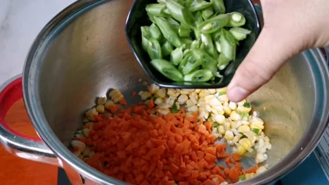 Tossing Chopped Beans in a Mixed Vegetables Stock Footage 236774380