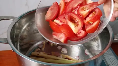 Tossing Chopped Tomatoes inside A Casserole Stock Footage 159292138