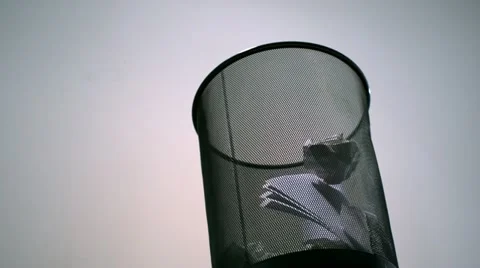 Tossing crushed paper into garbage can, Slow Motion Stock Footage 12159588