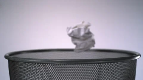 Tossing crushed paper into garbage can, Slow Motion Video stock 12161176
