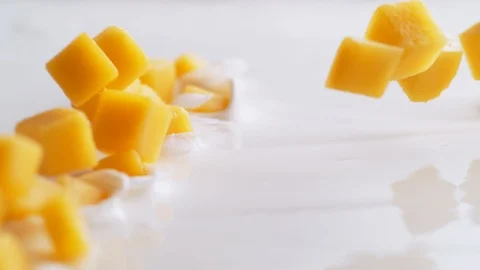 Tossing diced mango in yoghurt. Slow Motion. Stock Footage 94078209