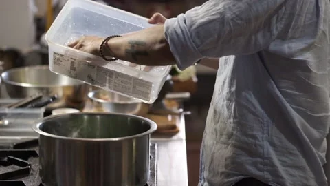 Tossing fresh vegetable into a pot  Stock Footage 145354769