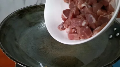 Tossing Raw Pork Belly Cubes in a Frying Pan Stock Footage 157676513