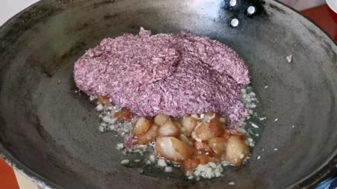 Tossing Raw Shrimp Paste on a Pork Cubes Stock Footage 231118998